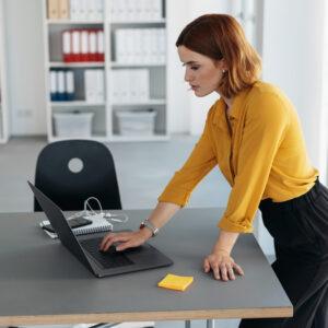 A young woman looking up what to know about wage and hour claims in California on her laptop.