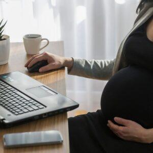 A pregnant woman at work. A lawyer can tell you what pregnancy discrimination is.